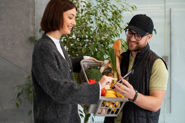 Delivery man giving groceries order to customer