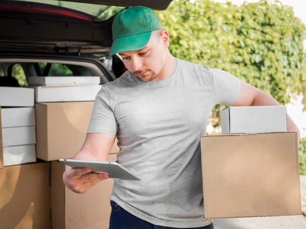 Delivery man holding tablet