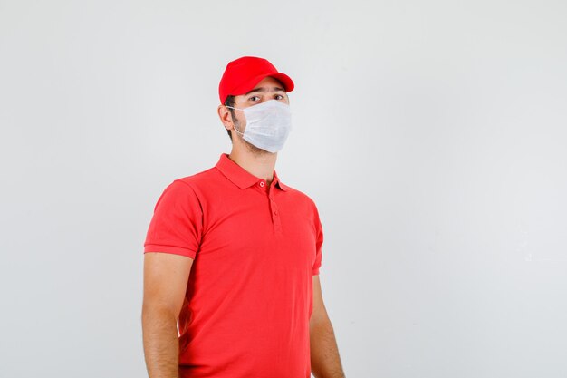 Delivery man looking at camera in red t-shirt