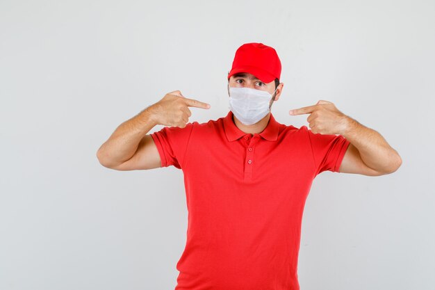 Delivery man pointing at mask in red t-shirt