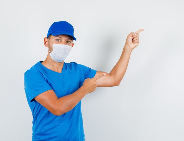 Delivery man pointing up fingers in blue t-shirt