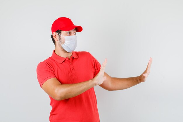 Delivery man showing stop gesture in red t-shirt