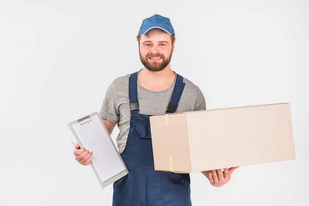 Delivery man standing with box and clipboard 