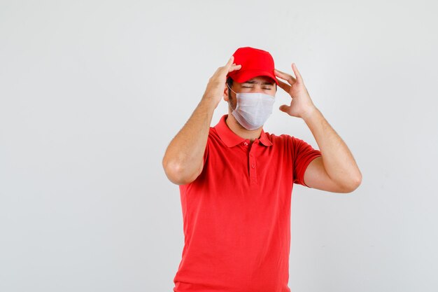 Delivery man suffering from headache in red t-shirt