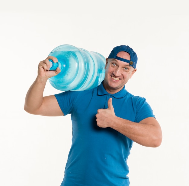 Delivery man thumbs up while carrying water bottle on shoulder