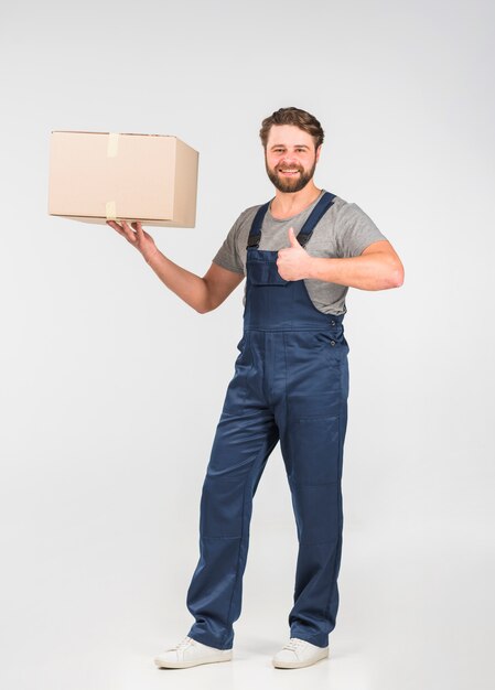 Delivery man with big box showing thumb up