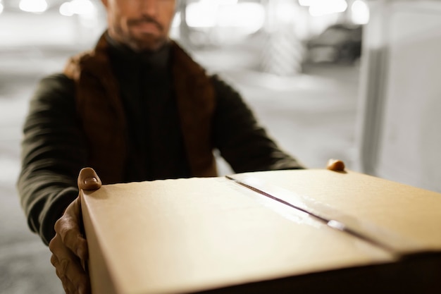 Delivery man with package close up