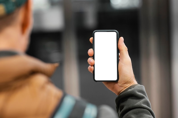 Delivery man with package at elevator with mobile