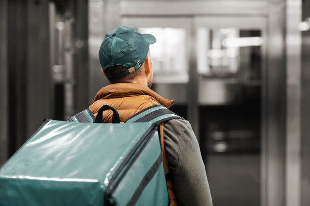 Delivery man with package at elevator