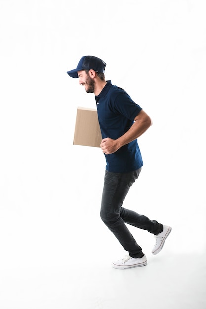Free photo delivery man with parcel running on white background
