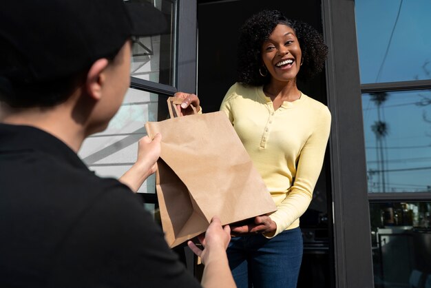 Free photo delivery person getting parcel out for delivery