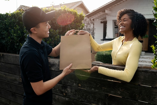 Free photo delivery person getting parcel out for delivery