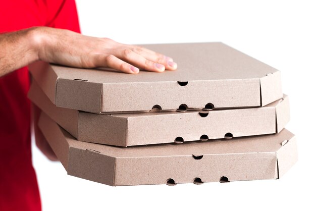 Delivery pizza boy holding boxes close-up