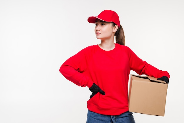 Delivery postal service asian woman holding and delivering package wearing red cap