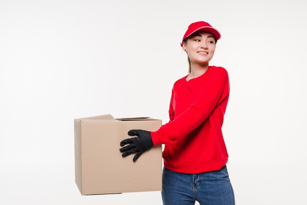 Delivery woman carrying cardboard box isolated on white 