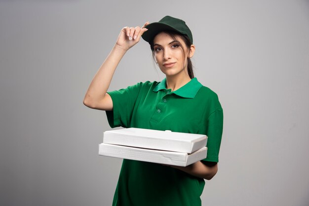 Delivery woman holding pizza 