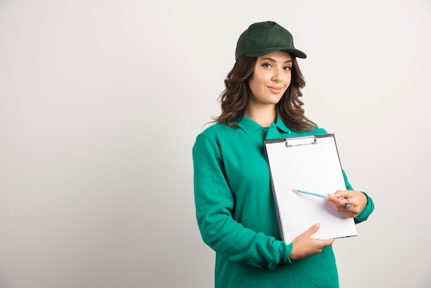 Delivery woman showing order detail on white.