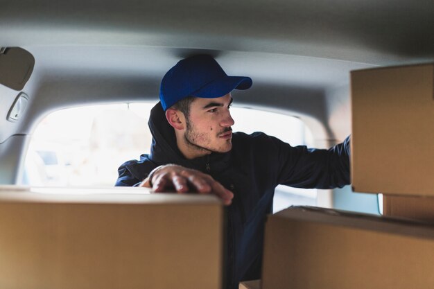 Deliveryman in car with boxes