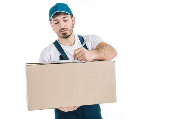 Deliveryman with parcel writing on clipboard