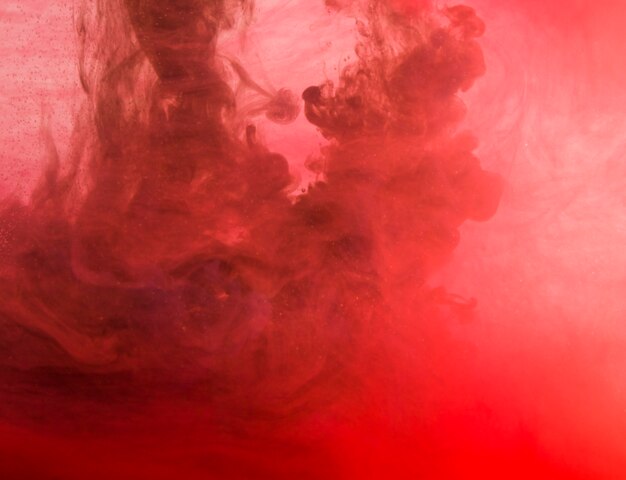 液体の曇りの濃い赤い雲