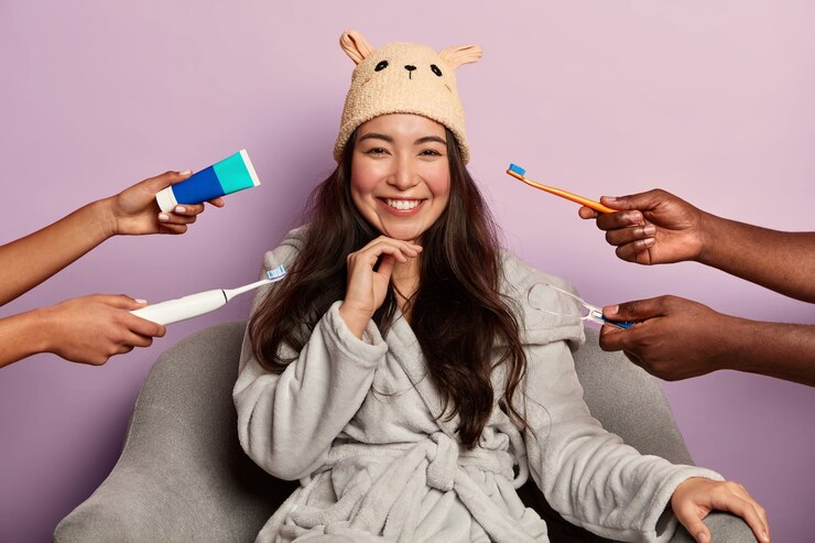 Dental care and oral hygiene concept with positive dark haired young woman