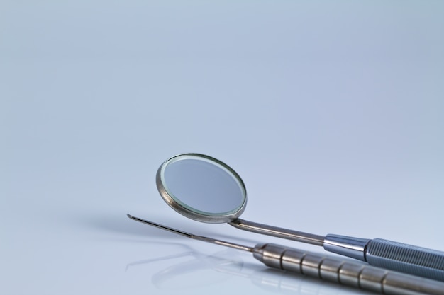 Dental tools and equipment on white background.