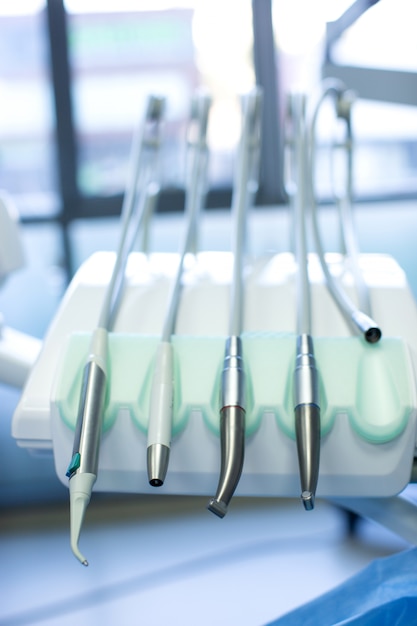 Dental tools with pipes fixed on dental chair