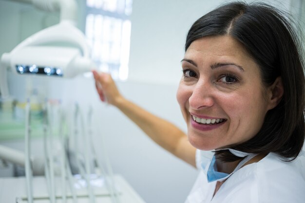 Dentist adjusting light