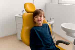 Free photo dentist cleaning child's teeth