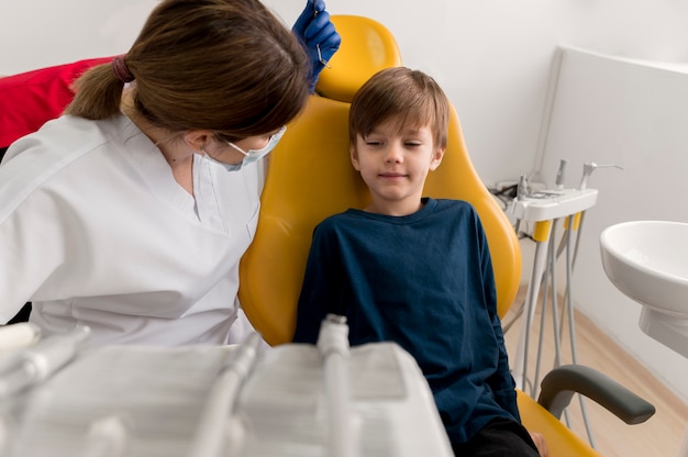 Dentist cleaning child's teeth