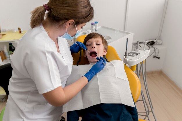 Dentist cleaning child's teeth