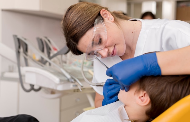 Dentist cleaning child's teeth