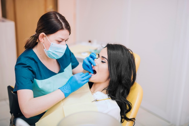 Dentist curing teeth of patient 