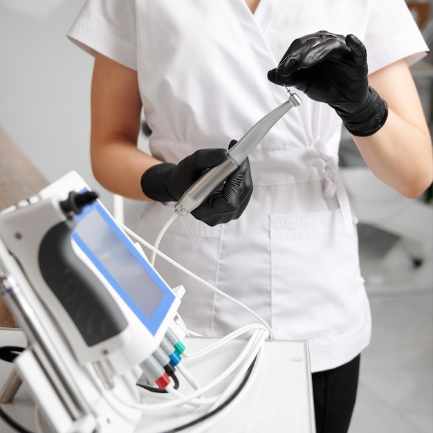 Dentist doctor hands holding dentist tools in dental clinic