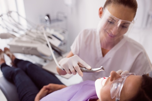 Dentist examining female patient