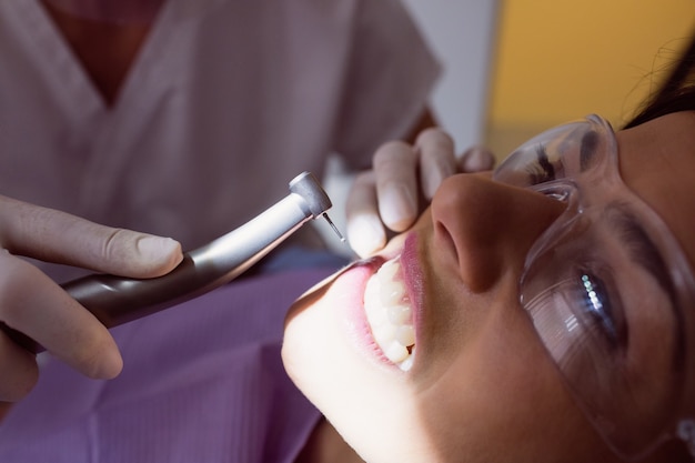 Dentist examining female patient