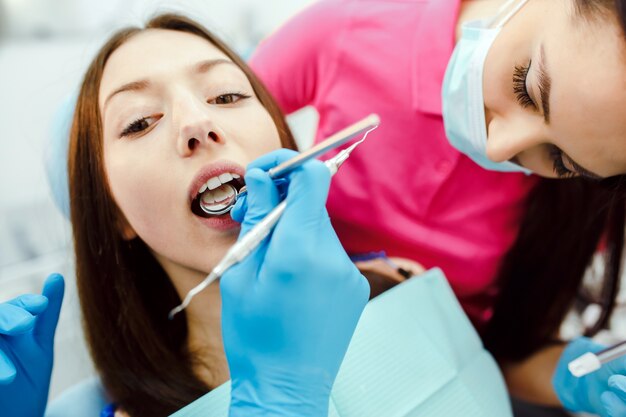 Dentist examining woman's teeth