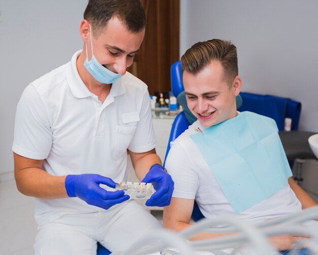 Dentist and patient looking at teeth