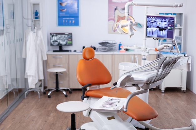 Dentist's office interior with modern chair and special dentisd equipment. The interior of stomatology clinic.