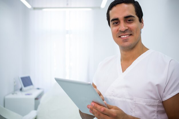 Dentist using a digital tablet at clinic