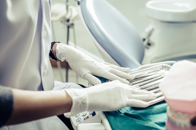 Free photo dentists choose equipment on the table.