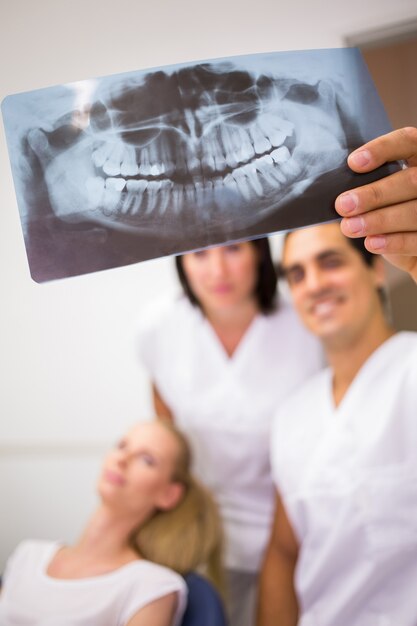 Dentists discussing over dental x-ray report