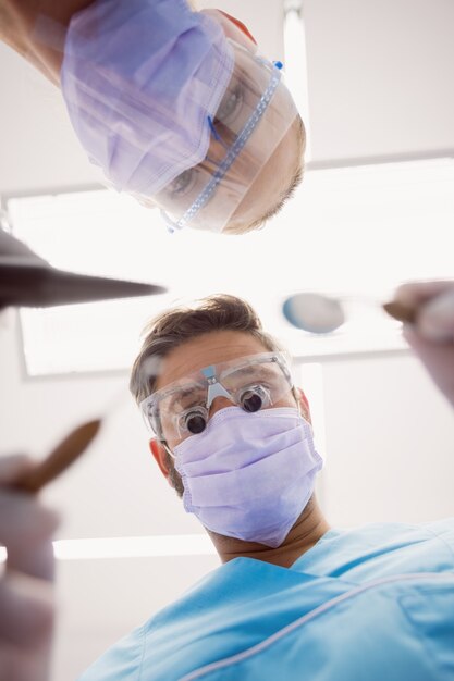 Dentists holding dental tools