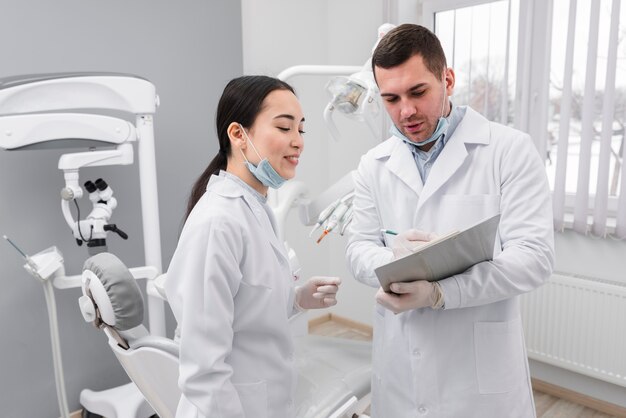 Dentists looking at clipboard