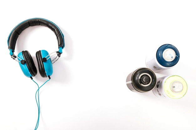 Deodorant bottle and headphone on white background