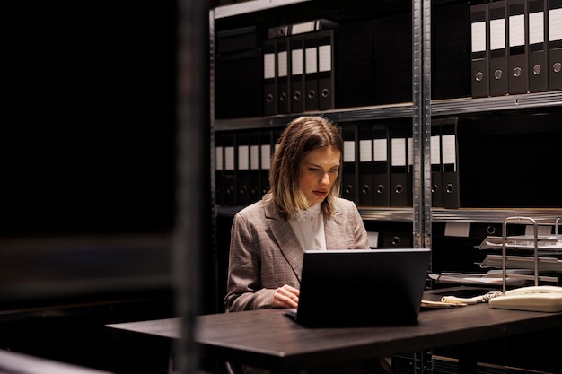 Free photo depository secretary discovering management files, working overhours at accountancy report in storage room. businesswoman reading bureaucracy record, analyzing administrative documents