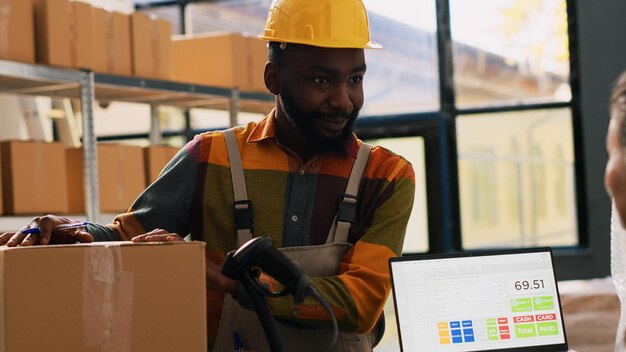 Depot worker checking logistics in packs on shelves, verifying order shipment for retail store. Female manger and employee looking at products boxes, quality control. Handheld shot.