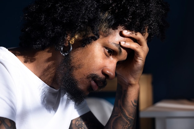 Free photo depressed black man side view