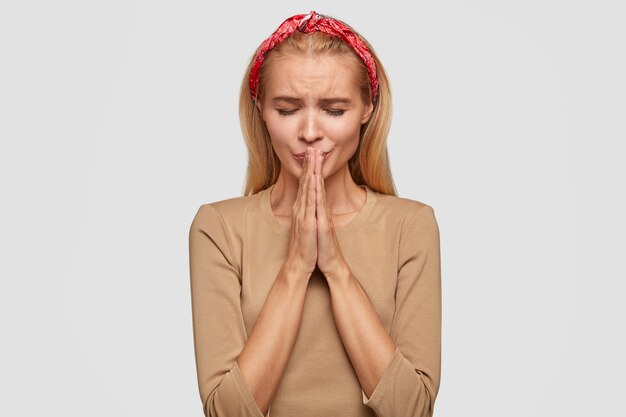 Depressed faithful female being in panic, has stressful situation, praying