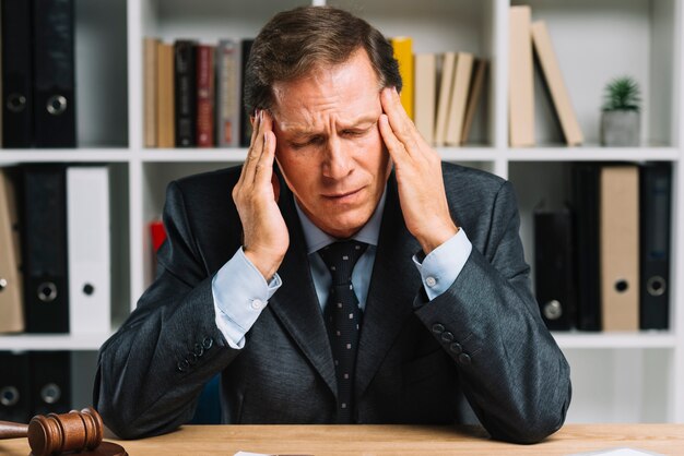 Depressed mature man feeling tired in the court room